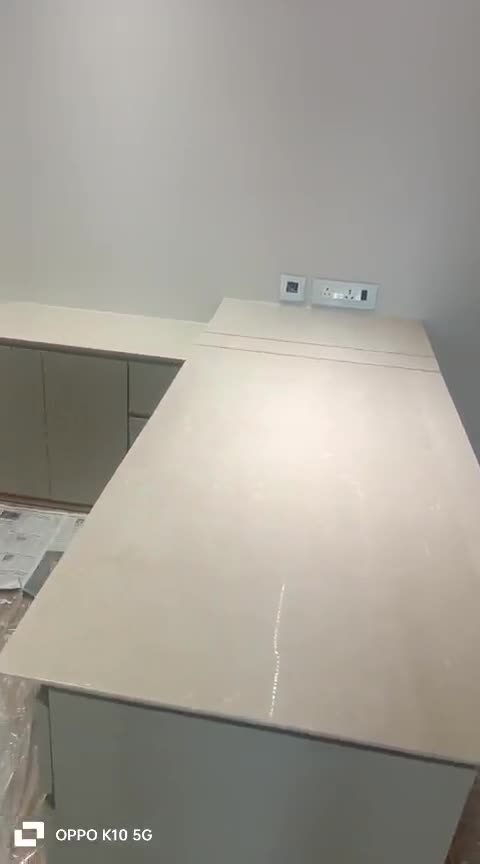 Still from a site walkthrough video showing a large stone counter top being finished